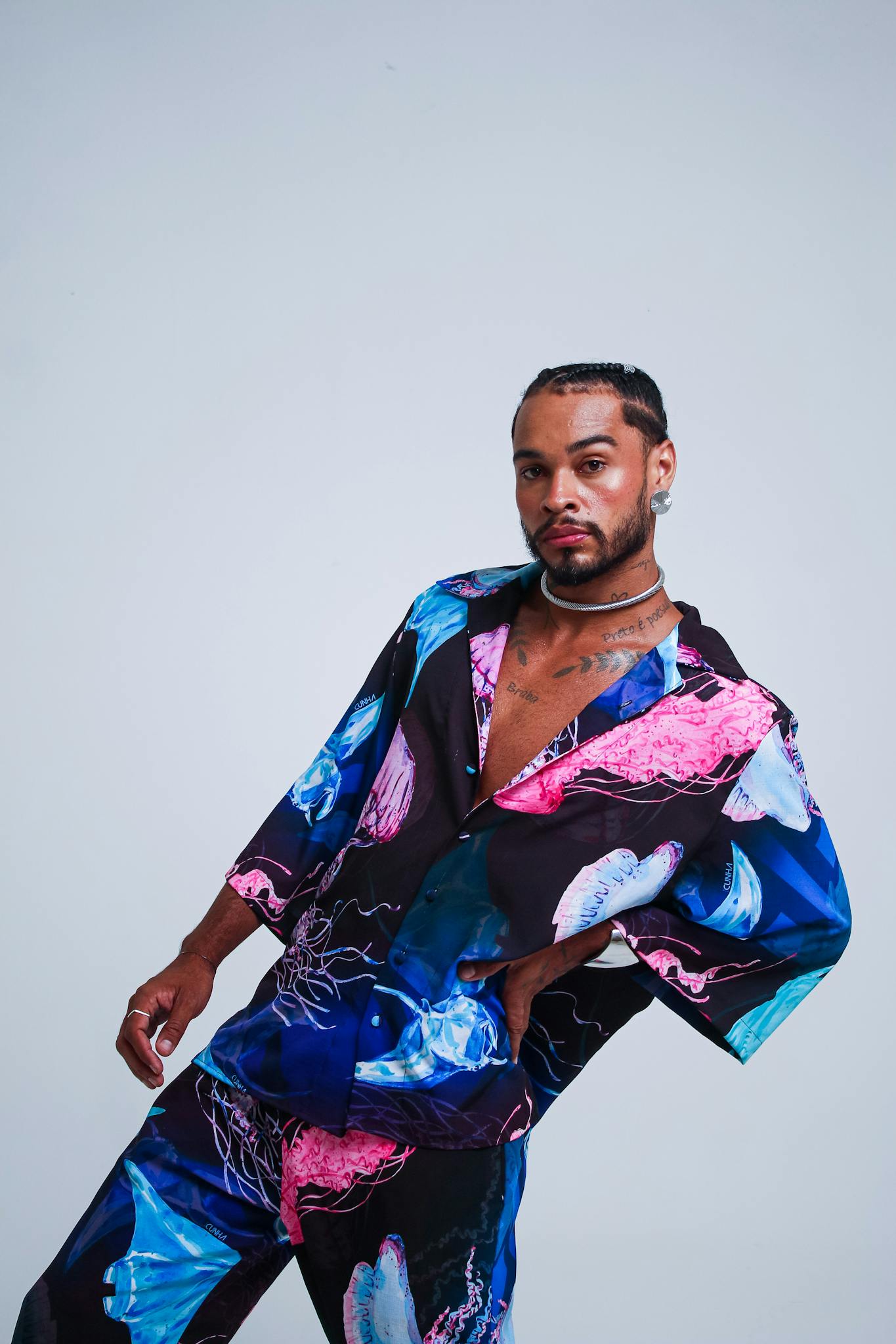 About A Stylish Young Man Poses In Colorful